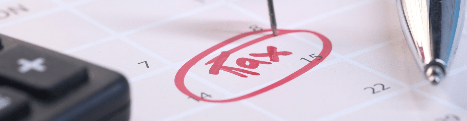 Close-up of a calendar with the word 'Tax' circled in red ink, marked with a pin, symbolizing a critical tax deadline or planning date.